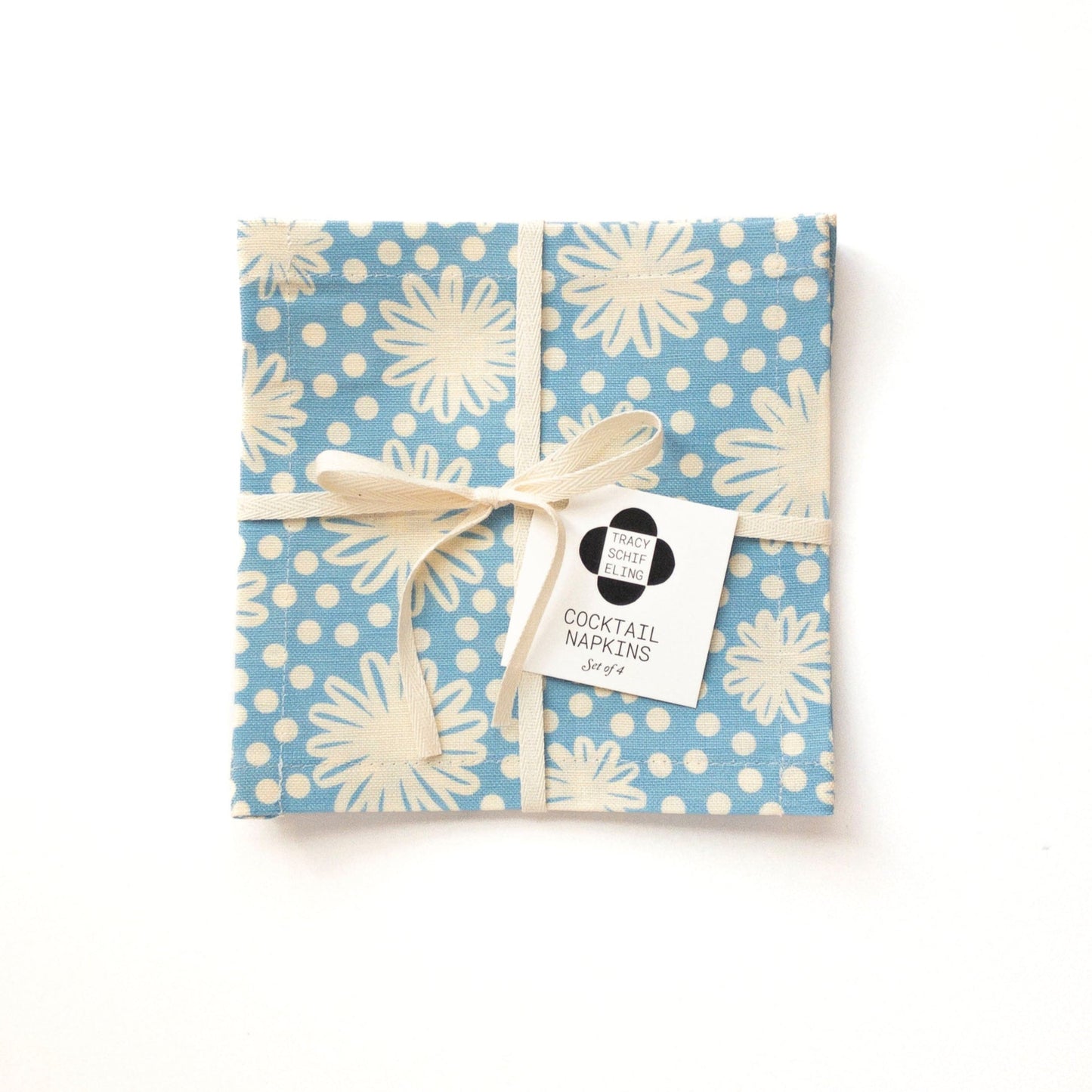 Packaged cocktail napkin set with blue and white floral pattern on a white background