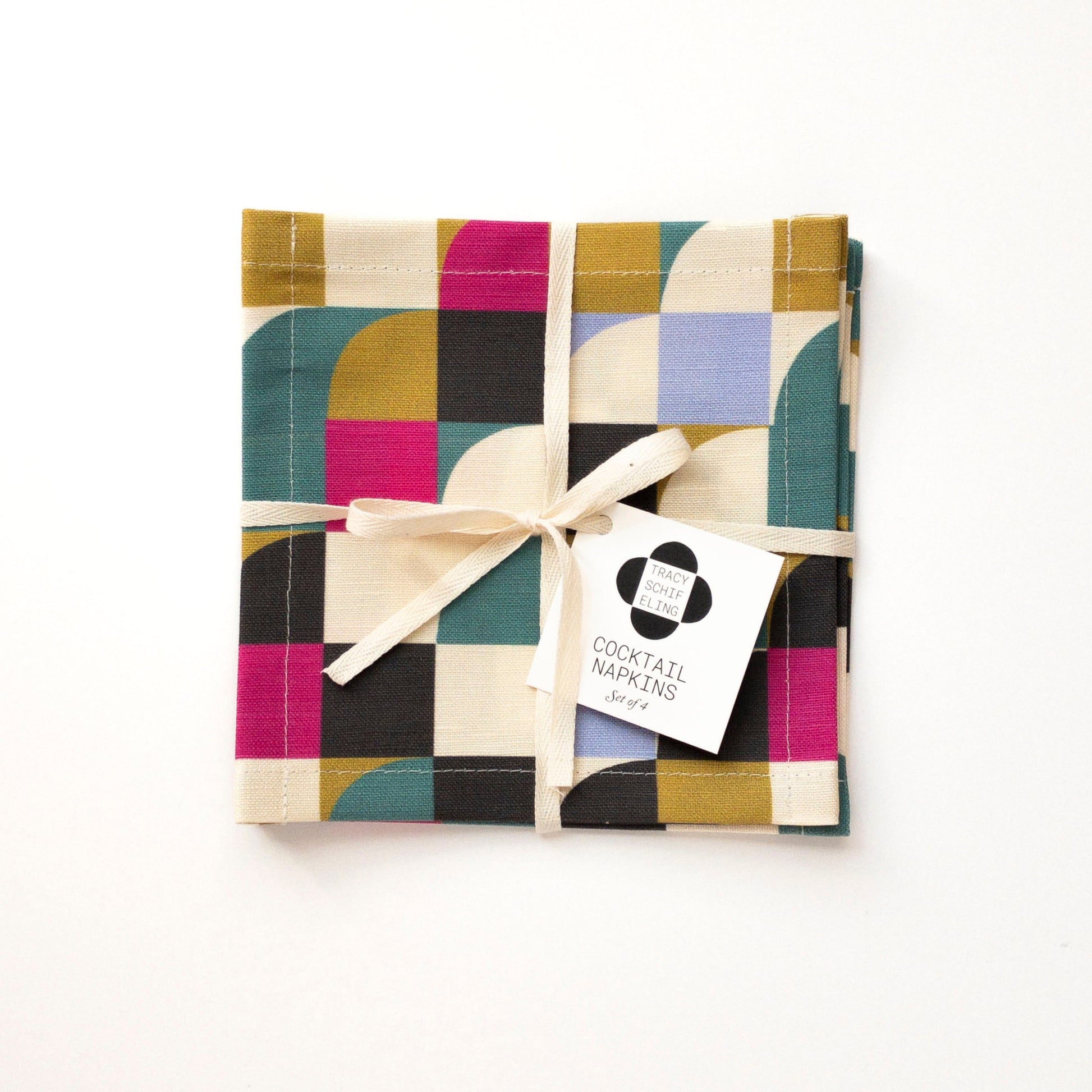 Pack of colorful cocktail napkins with a decorative bow on a white background