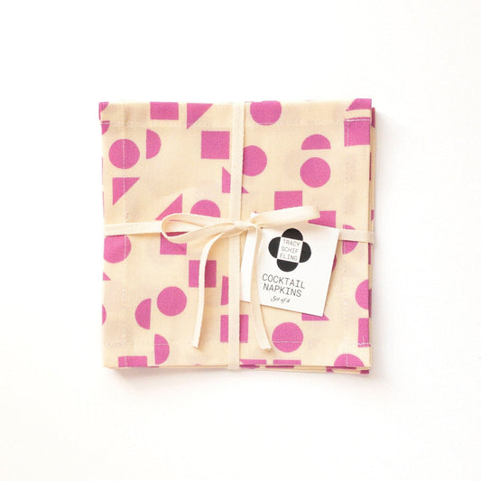 Pack of cocktail napkins with purple polka dots on a white background