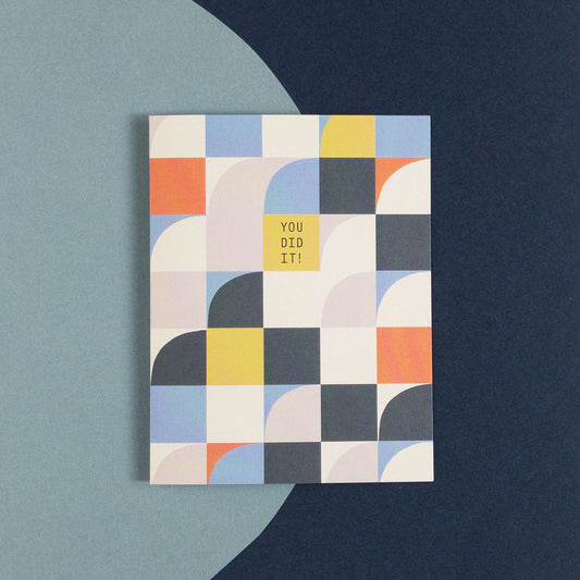 Geometric greeting card that says You Did It! on a blue background.