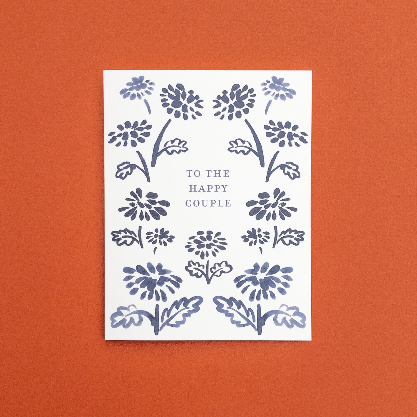 Wedding greeting card with navy floral border design and 'To the Happy Couple' text.