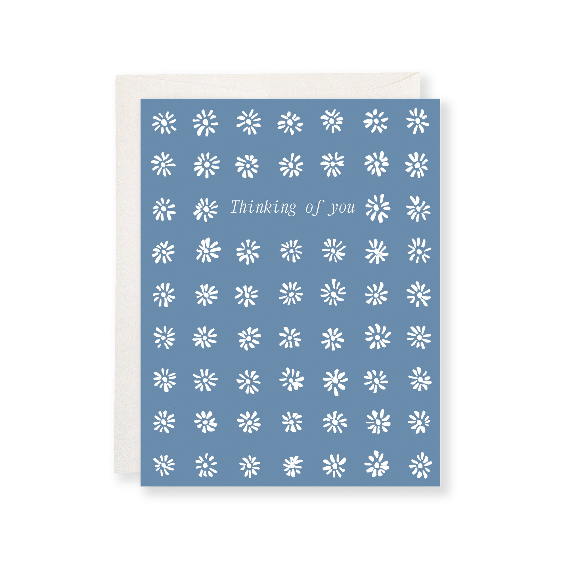 Blue card with white floral pattern and 'Thinking of you' text on a white background
