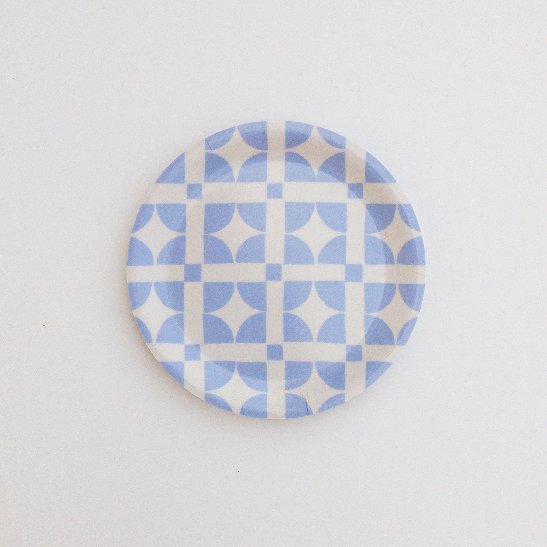 Round coaster featuring a light blue geometric pattern on a white background.