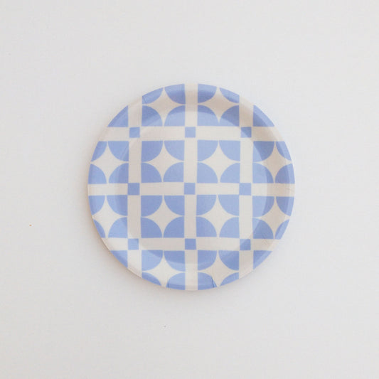 Round coaster featuring a light blue geometric pattern on a white background.