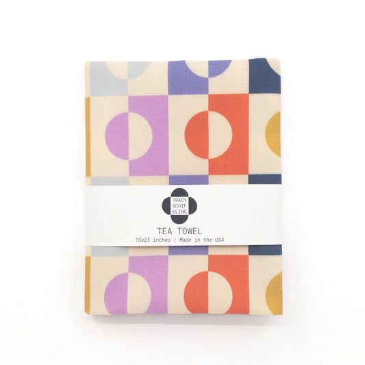 Colorful geometric tea towel featuring a pattern of circles and squares.