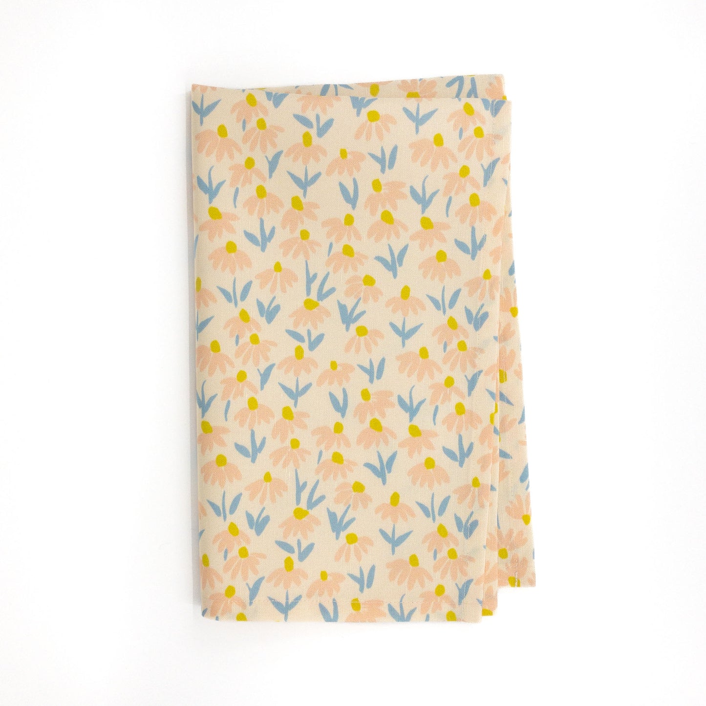 Folded floral tea towel on a white background.