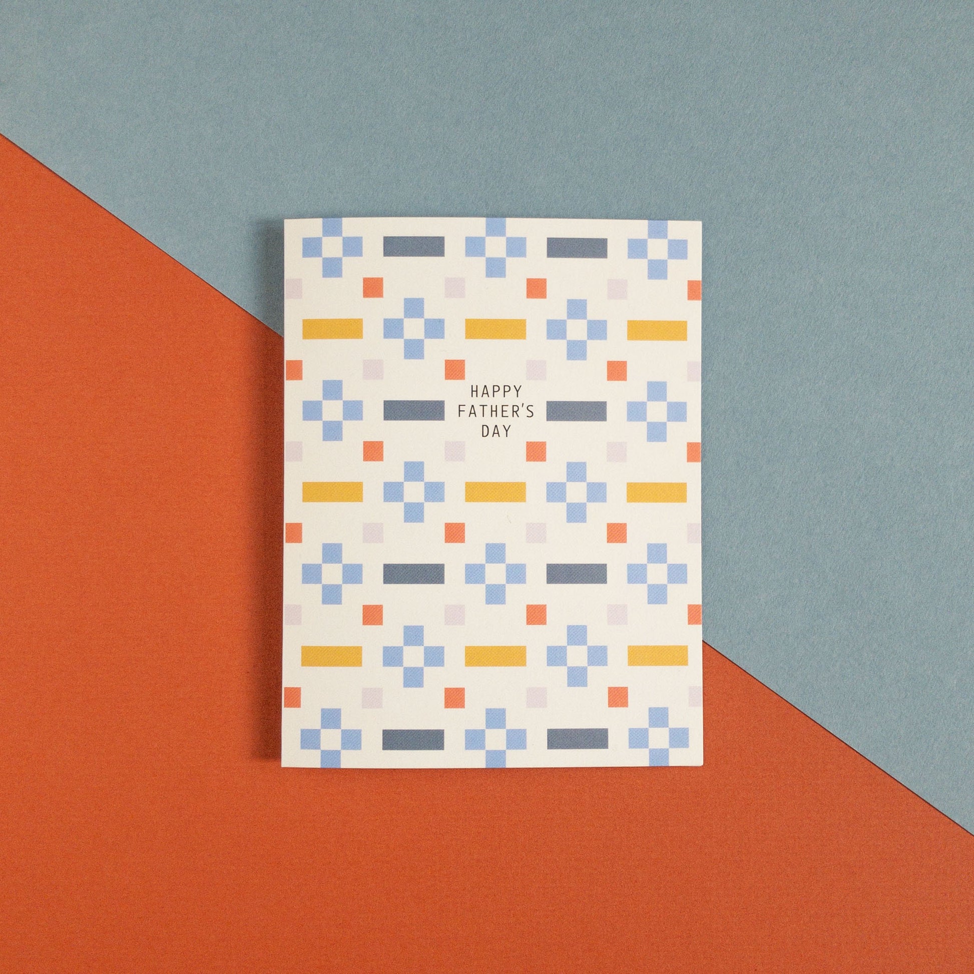 Geometric Father's Day greeting card on a blue and orange background.