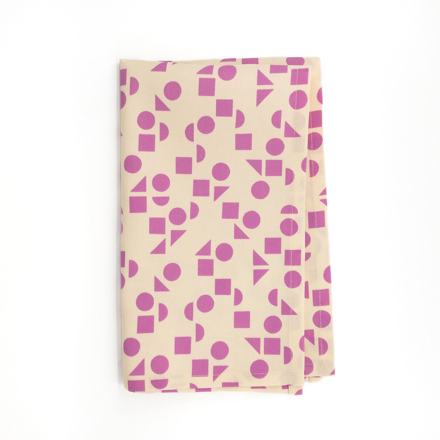 Vibrant geometric tea towel on a white background.