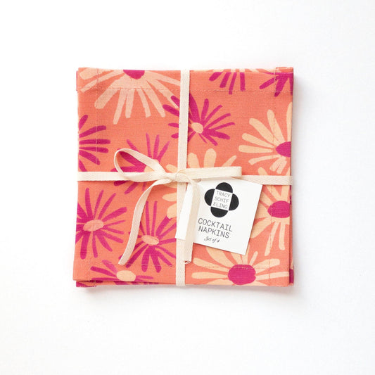Pack of cocktail napkins with floral design and visible brand label on a white background