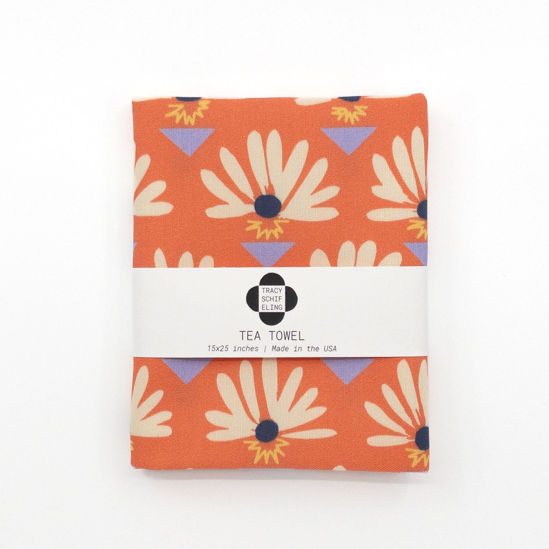 Folded and packaged red tea towel featuring daisies and blue triangles.