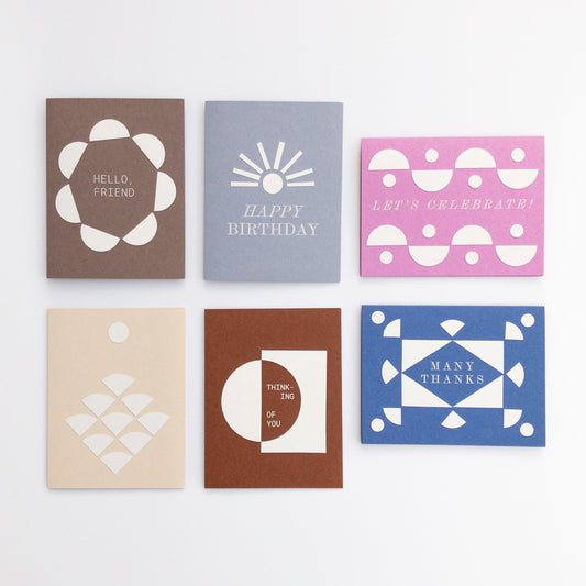Set of six greeting cards with geometric designs and text on a white background