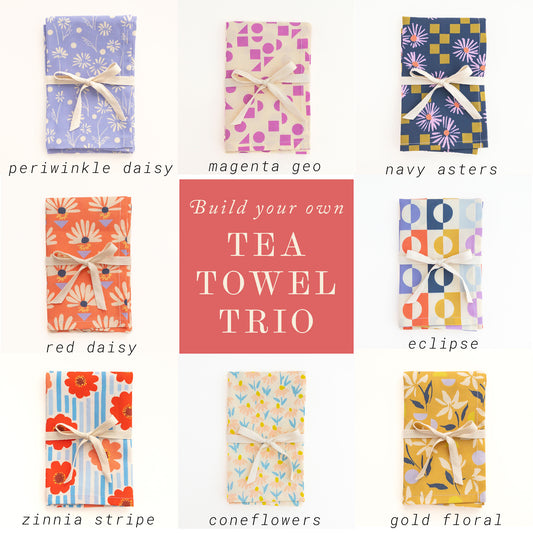 Collection of patterned tea towels with text indicating color options and 'Build your own Tea Towel Trio'.