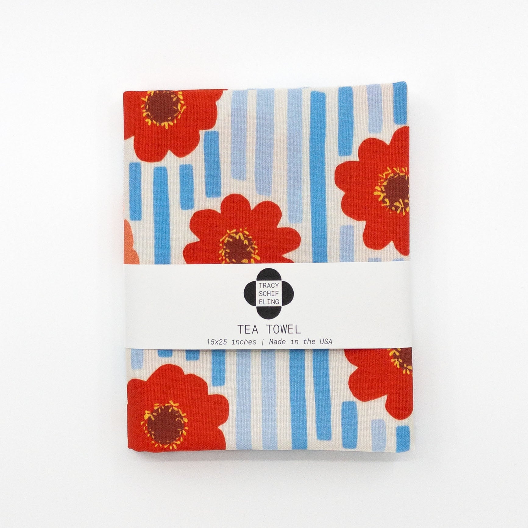 Folded and packaged tea towel featuring red zinnia flowers and blue stripes.