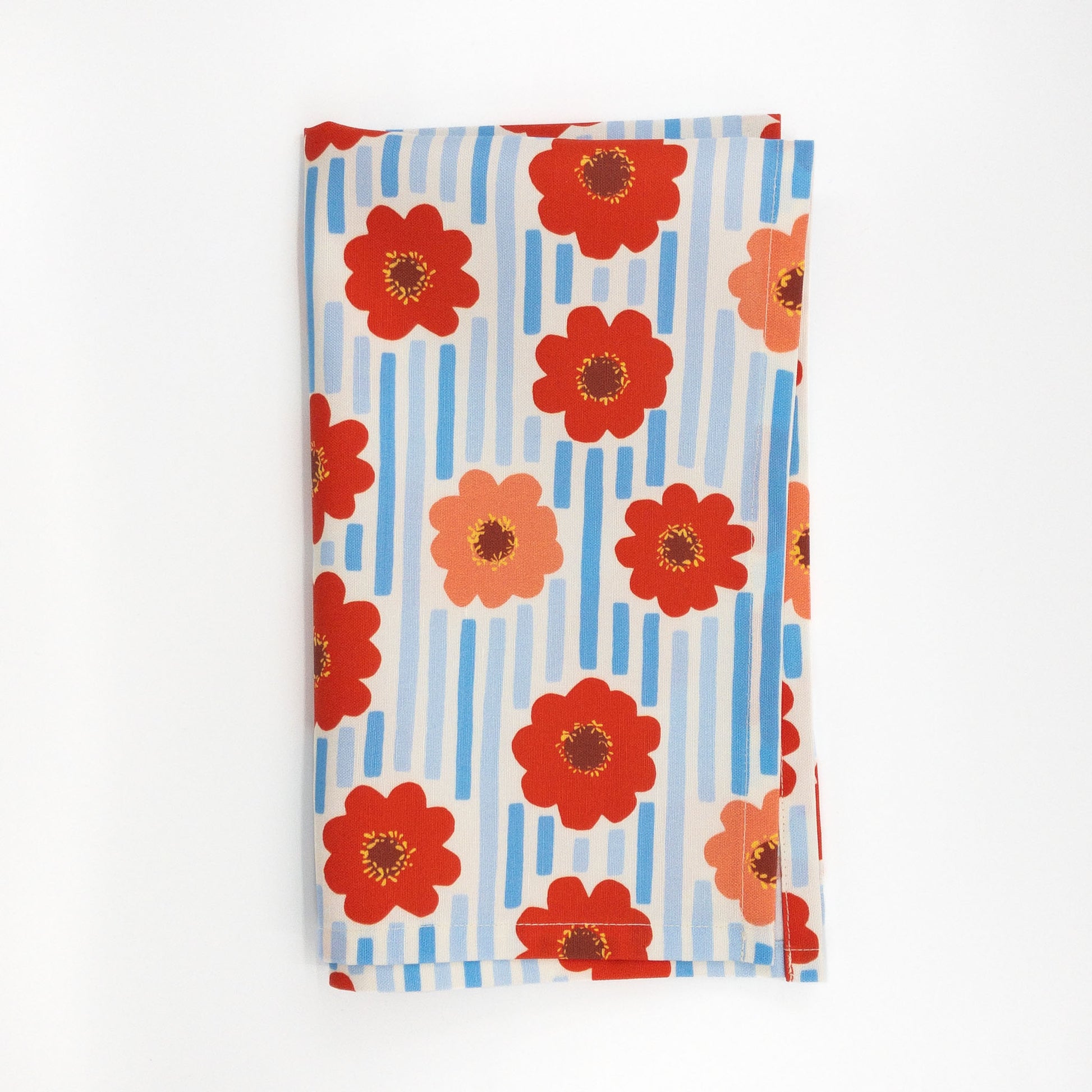 Folded tea towel with red flowers and blue stripes on a white background.